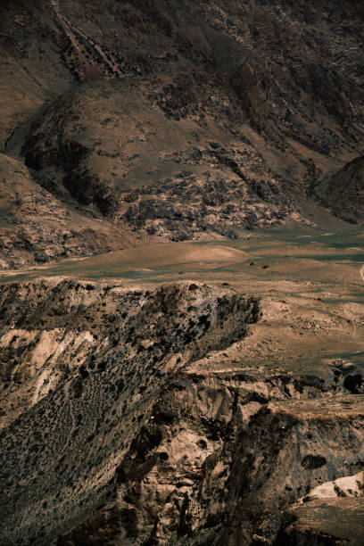 istock Sandy-hued mountain terrain intersected by off-road trails 2161158095