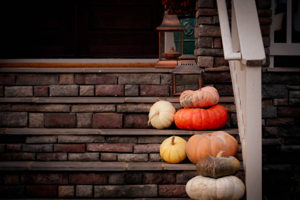 Pumpkins and gourds decorate front porch steps
