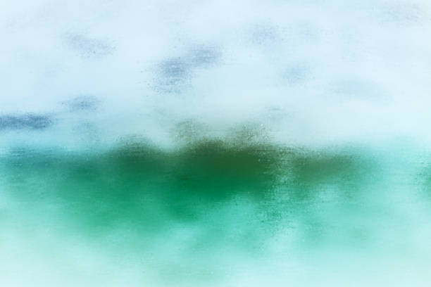 istock Abstract background texture referencing a blue sky with clouds floating over a green field with mountains in the distance. 2161166792