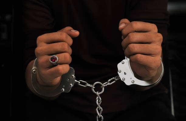 istock prisoner concept,Handcuffed hands of a prisoner in prison, 2161167450