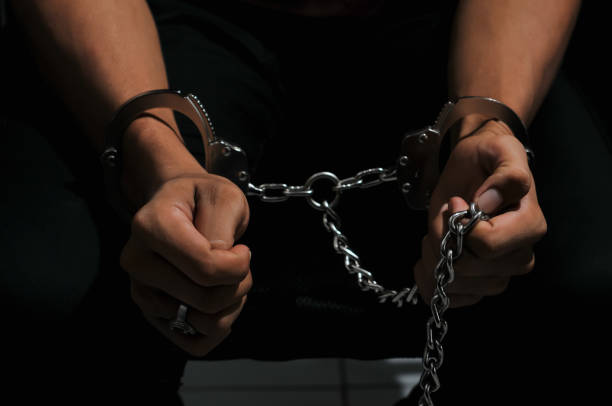 istock prisoner concept,Handcuffed hands of a prisoner in prison, 2161167659
