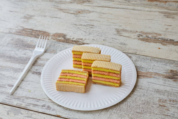 istock Yellow pink sponge cake with waffles and jam on a white plate, home baking, fruit sponge cake, closeup 2161172345