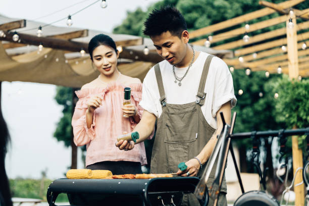 istock Asian young couple smiling at camp on vacation in backyard 2161173746