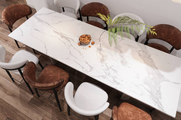 istock A stem into a Pot and some nuts on the Marble table, White and Brown Chairs setting on the hardwood flooring. 3D rendering 2161175940