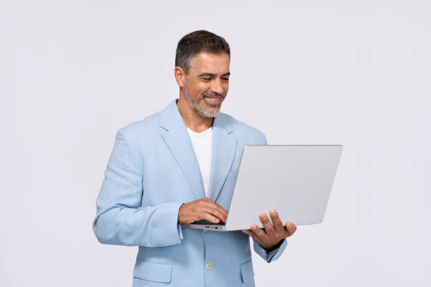 istock Happy middle aged business man using laptop isolated on white background. 2161177273