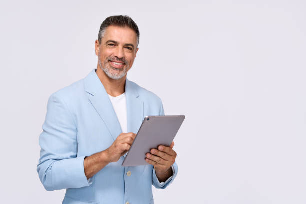 istock Happy middle aged business man wearing suit using digital tablet, isolated. 2161177274