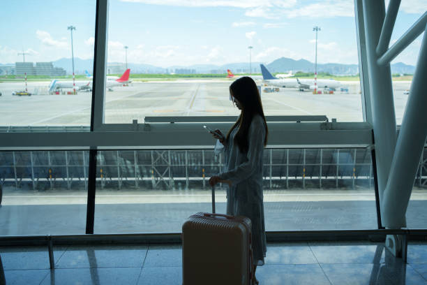 istock Passengers looking at mobile phones in the terminal 2161177576