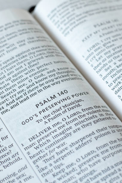 istock Psalm 140 verses in open holy bible book, close-up 2161179600