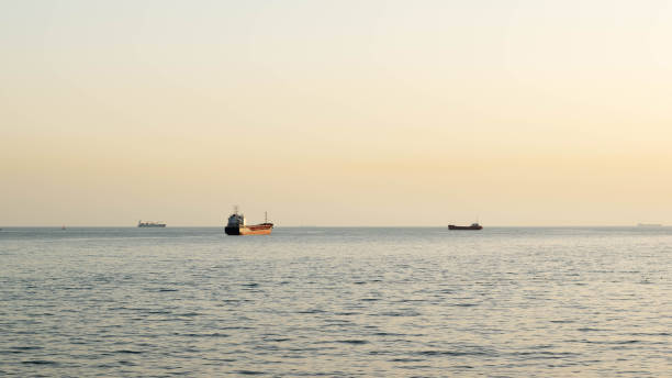 istock Serene Sea at Dusk with Cargo Ships on the Horizon and Tranquil Waters 2161181906