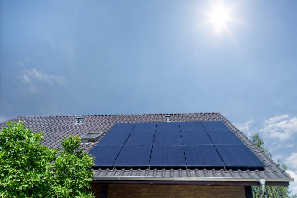 istock Solar Panels on Roof Under Bright Sun 2161182279