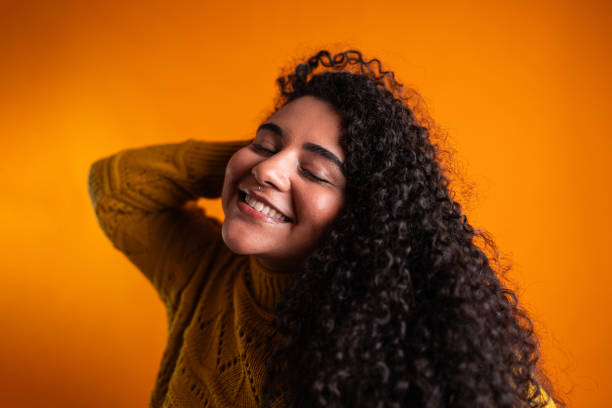 istock Young woman on a orange background 2161184344