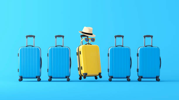 istock Yellow suitcase standing in terminal, full of blue suitcases 2161186507