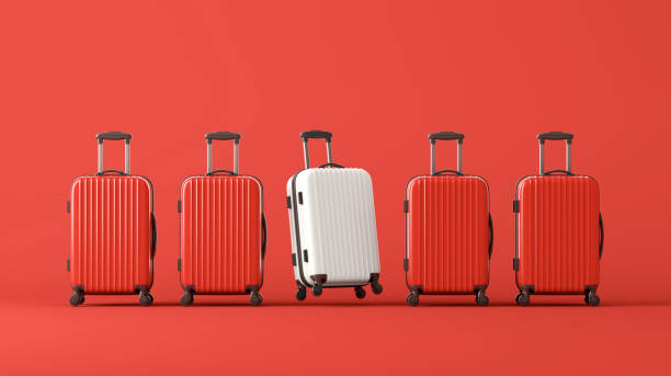istock White suitcase standing in terminal, full of red suitcases 2161186529