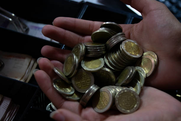 istock Person with Colombian coins 2161187353