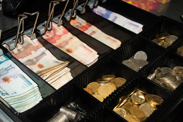 istock cash register with Colombian banknotes 2161187408