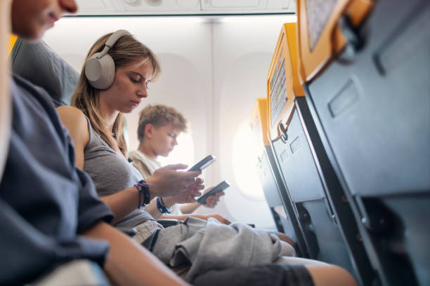 istock Three teenagers travelling in a plane 2161187420