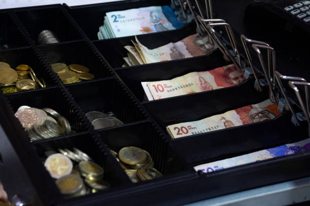 istock cash register with Colombian banknotes 2161187425