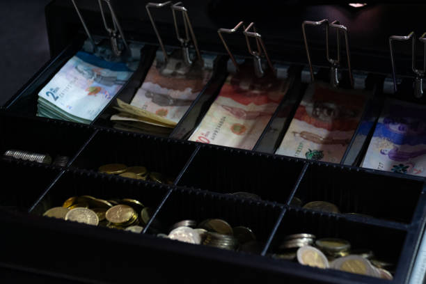 istock cash register with Colombian banknotes 2161187427