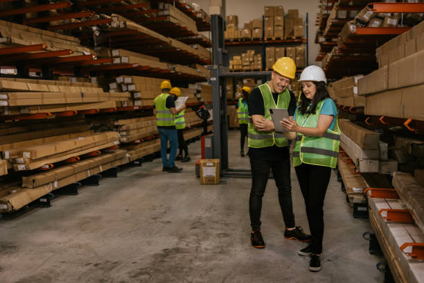 istock Warehouse workers reviewing inventory on tablet 2161187683
