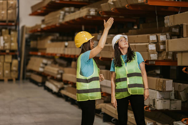 istock Two female workers inspecting inventory in a warehouse 2161188180
