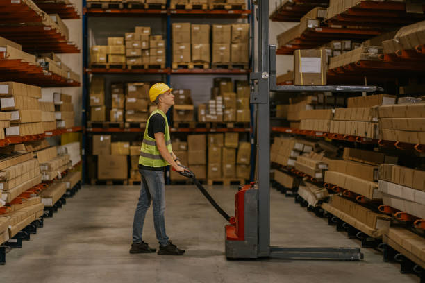 istock Warehouse worker operating forklift in a busy distribution center 2161189063