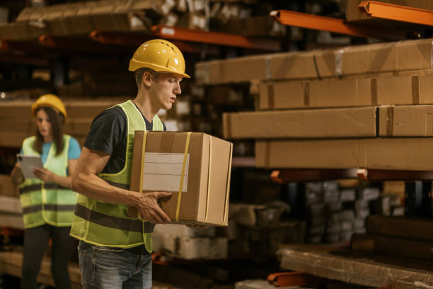 istock Warehouse worker carrying box during inventory in industrial facility 2161189314