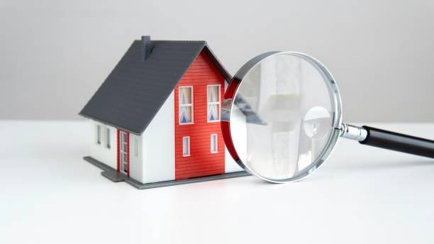 istock Model House with Magnifying Glass for Real Estate Evaluation 2161192443