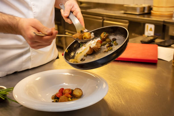 istock Male chef garnishing his dish, ready to serve 2161193224