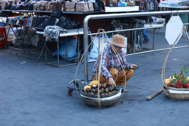 Hoi An, Vietnam July 5 2024:  the local sell the fruit by carrying pole. old town was a Southeast Asian trading port from the 15th to 19th century, now it become the resort city.