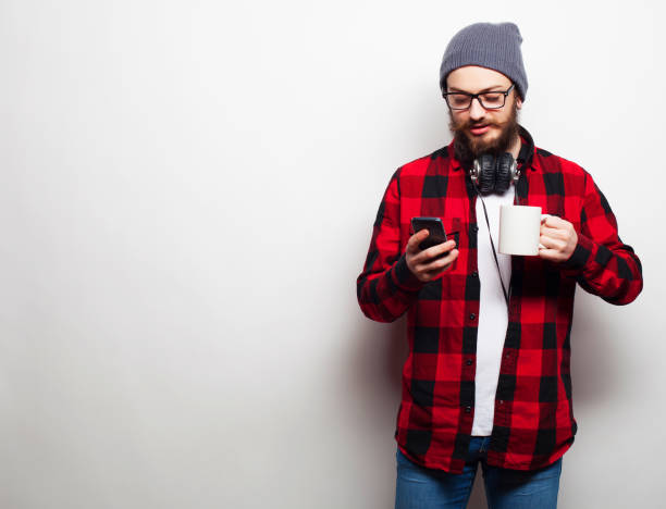 istock young bearded man with mobile phone 2161195560