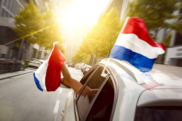 Fans with Dutch Flag Celebrating in a Car
