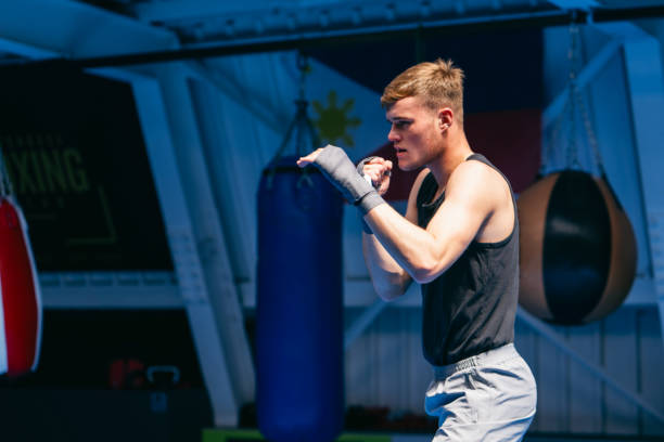 istock Young man shadow boxing in gym 2161199678