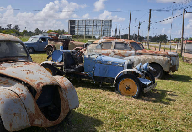 Several old and rusty cars on the road eleven