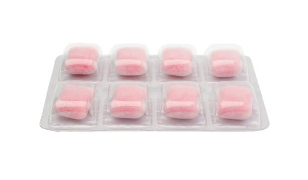 Mint chewing gum in the shape of a pillow on a white background
