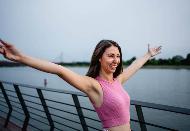 istock Young happy woman enjoying by the river 2161204016