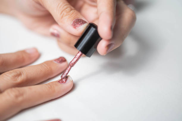 istock Applying glittery pink nail polish 2161204817