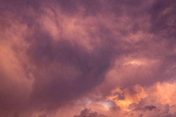 Dramatic storm clouds glowing in red and magenta
