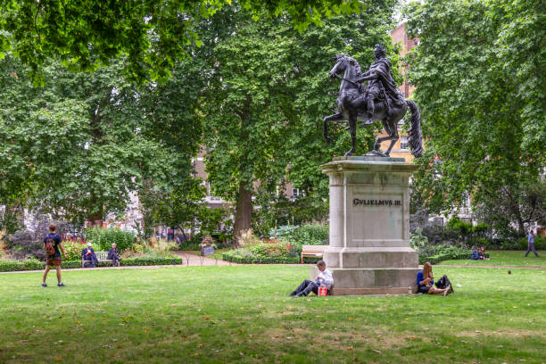 London, England, July 19, 2017; People enjoy St James's Square park in central London.
