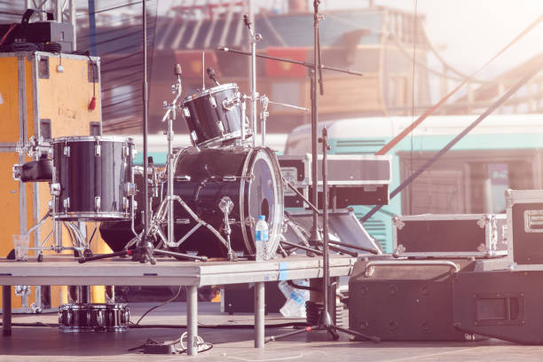 Guitar Pedals on a Stage with Live Band Performing During a Show. Low light image with copyspace