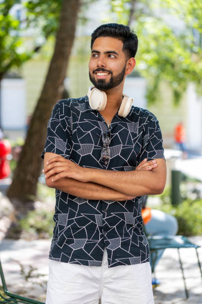 istock Portrait of happy Indian man smiling friendly, glad expression looking at camera with headphones 2161217191