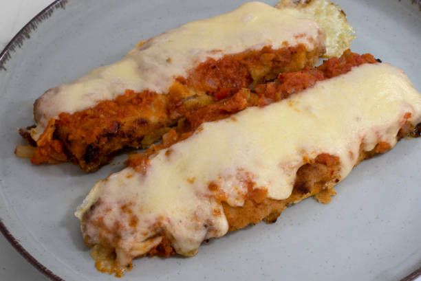 istock Two fish filets with tomato sauce and gratin cheese 2161219932