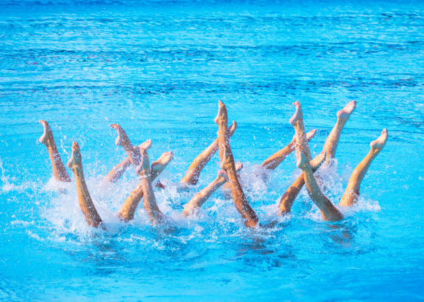istock Artistic swimming team performing synchronized legs movement in swimming pool 2161220050