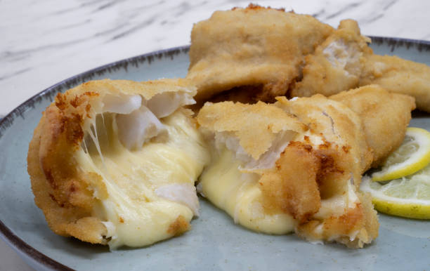 istock View of two fried and breaded hake fillets stuffed with mozzarella cheese. 2161220943