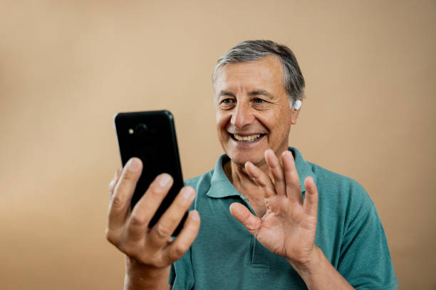 istock Senior man making video call on a beige background 2161222311