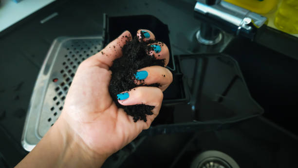 istock A hand with blue nail polish holds the leftover coffee grounds from the coffee machine 2161222734