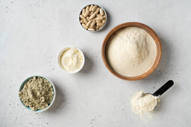 istock Different powder protein with scoop in plates 2161225651