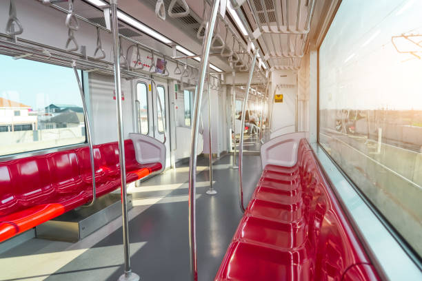 istock Red plastic seats and chrome handrails inside an electric train carriage car 2161225882
