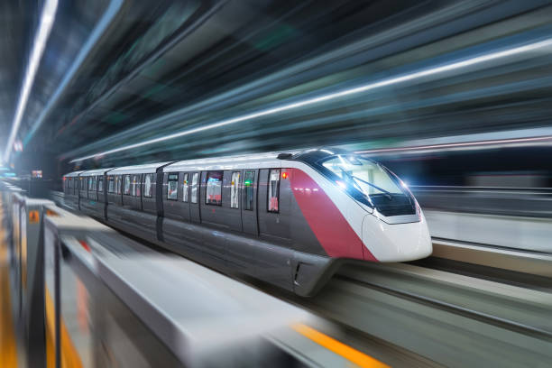 istock Modern high speed monorail train with bright headlights passes through the station. 2161227226