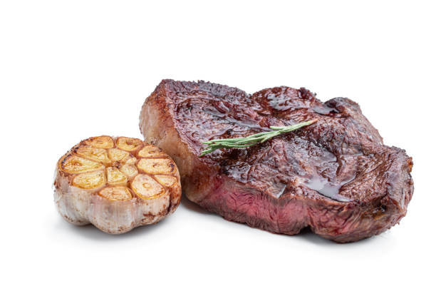 istock Fried beef steak with herbs isolated on white 2161228364