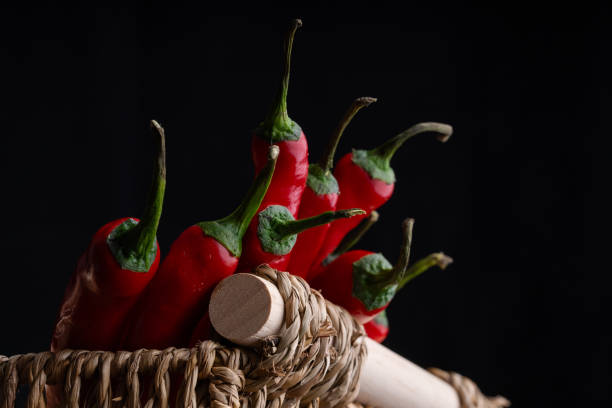 Red hot pepper in a wicker basket. Still life with chili pepper.